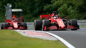 Ferrari driver Sebastian Vettel of Germany steers his car followed by Ferrari driver Charles
