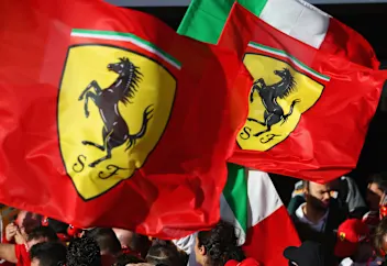 MELBOURNE, AUSTRALIA - MARCH 25: The Ferrari team wave flags at the podium during the Australian