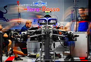 SUZUKA, JAPAN - OCTOBER 11: The Scuderia Toro Rosso team work in the garage after practice for the