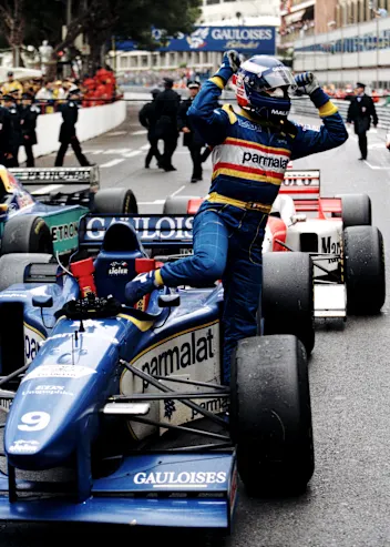 Olivier Panis with arms aloft climbs from his #9 Equipe Ligier Gauloises Blondes Ligier JS43