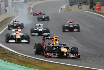 SAO PAULO, BRAZIL - NOVEMBER 25:  Sebastian Vettel of Germany and Red Bull Racing leads a train of cars through turn one during the Brazilian Formula One Grand Prix at the Autodromo Jose Carlos Pace on November 25, 2012 in Sao Paulo, Brazil.  (Photo by Mark Thompson/Getty Images)