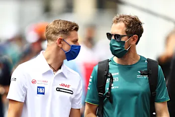 BAKU, AZERBAIJAN - JUNE 04: Mick Schumacher of Germany and Haas F1 talks with Sebastian Vettel of