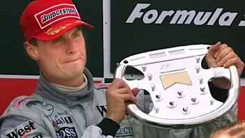 Scottish McLaren-Mercedes driver David Coulthard holds his trophy on the podium of the Montmelo