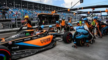 McLaren's Australian driver Daniel Ricciardo arrives at the pits for the first practice for the