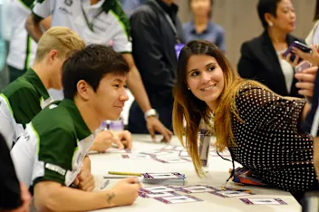 Kamui Kobayashi (JPN) Caterham with a fan in the autograph session. Formula One World
