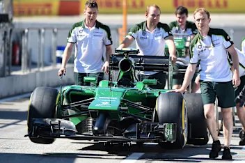 Caterham CT05 and Caterham mechanics in pit lane. Formula One World Championship, Rd10, German
