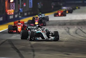 SINGAPORE STREET CIRCUIT, SINGAPORE - SEPTEMBER 16: Lewis Hamilton, Mercedes AMG F1 W09 EQ Power+ leads Sebastian Vettel, Ferrari SF71H during the Singapore GP at Singapore Street Circuit on September 16, 2018 in Singapore Street Circuit, Singapore. (Photo by Simon Galloway / Sutton Images)