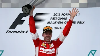 Race winner Sebastian Vettel (GER) Ferrari celebrates on the podium with the trophy at Formula One