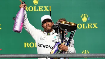 Race winner Lewis Hamilton (GBR) Mercedes AMG F1 celebrates on the podium with the champagne and