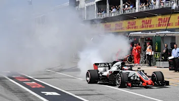 Romain Grosjean (FRA) Haas VF-18 smokes in pit lane in Q1 at Formula One World Championship, Rd7,