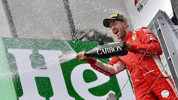 Race winner Sebastian Vettel (GER) Ferrari celebrates with the champagne on the podium at Formula