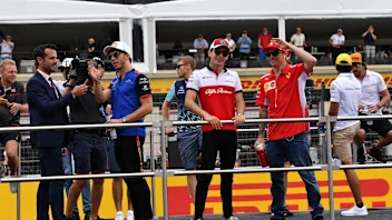 Charles Leclerc (MON) Alfa Romeo Sauber F1 Team and Kimi Raikkonen (FIN) Ferrari on the drivers