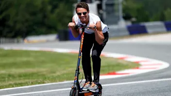 RED BULL RING, AUSTRIA - JUNE 27: Lando Norris, McLaren walks the track on scooters during the