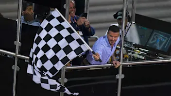 BAHRAIN INTERNATIONAL CIRCUIT, BAHRAIN - MARCH 31: David Beckham waves the chequered flag during