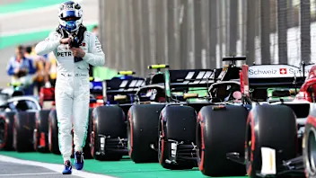 SAO PAULO, BRAZIL - NOVEMBER 16: Valtteri Bottas of Finland and Mercedes GP walks in parc ferme