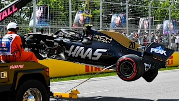 CIRCUIT GILLES-VILLENEUVE, CANADA - JUNE 08: Marshals remove the damaged car of Kevin Magnussen,