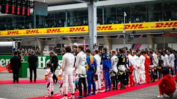 SHANGHAI INTERNATIONAL CIRCUIT, CHINA - APRIL 14: The drivers stand for the national anthem prior