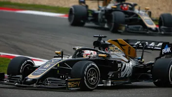 SHANGHAI INTERNATIONAL CIRCUIT, CHINA - APRIL 14: Romain Grosjean, Haas VF-19, leads Kevin