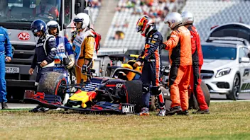 HOCKENHEIMRING, GERMANY - JULY 26: Marshals and doctors assist Pierre Gasly, Red Bull Racing RB15,