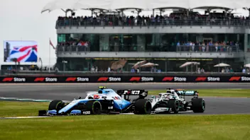 SILVERSTONE, UNITED KINGDOM - JULY 13: Robert Kubica, Williams FW42, leads Lewis Hamilton, Mercedes
