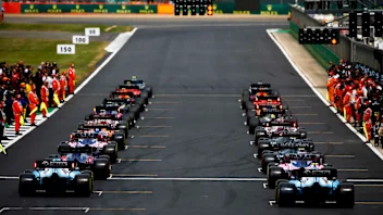 SILVERSTONE, UNITED KINGDOM - JULY 14: Mechanics clear the grid as the drivers prepare to head off