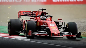 SUZUKA, JAPAN - OCTOBER 11: Sparks fly behind Sebastian Vettel of Germany driving the (5) Scuderia