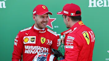 SUZUKA, JAPAN - OCTOBER 13: Top two qualifiers Sebastian Vettel of Germany and Ferrari and Charles