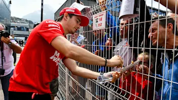 MONTE CARLO, MONACO - MAY 22: Charles Leclerc, Ferrari signs an autograph for a fan during the