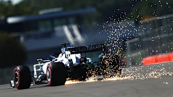 NORTHAMPTON, ENGLAND - AUGUST 07: Sparks fly behind Daniil Kvyat of Russia driving the (26)