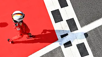 NORTHAMPTON, ENGLAND - AUGUST 09: Sebastian Vettel of Germany and Ferrari walks in parc ferme