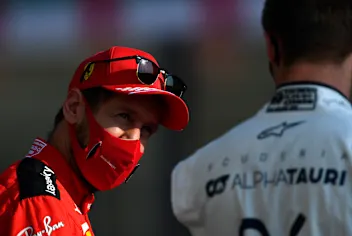 ABU DHABI, UNITED ARAB EMIRATES - DECEMBER 13: Sebastian Vettel of Germany and Ferrari talks with