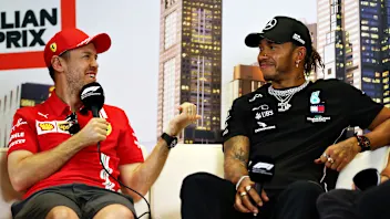 MELBOURNE, AUSTRALIA - MARCH 12: Sebastian Vettel of Germany and Ferrari and Lewis Hamilton of