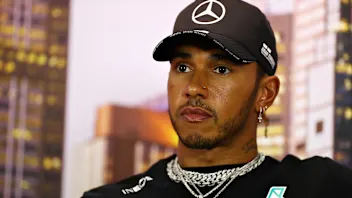 MELBOURNE, AUSTRALIA - MARCH 12: Lewis Hamilton of Great Britain and Mercedes GP talks in the