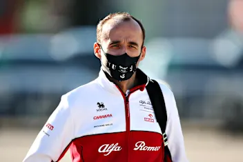 PORTIMAO, PORTUGAL - OCTOBER 24: Robert Kubica of Poland and Alfa Romeo Racing walks in the Paddock