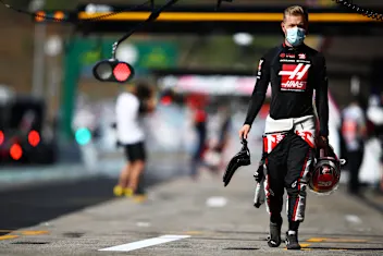 PORTIMAO, PORTUGAL - OCTOBER 24: Kevin Magnussen of Denmark and Haas F1 walks in the Pitlane during