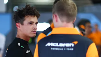 SUZUKA, JAPAN - SEPTEMBER 22: Lando Norris of Great Britain and McLaren talks with a McLaren team