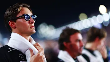 LUSAIL CITY, QATAR - OCTOBER 06: George Russell of Great Britain and Mercedes walks in the Paddock