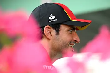 SINGAPORE, SINGAPORE - SEPTEMBER 14: Carlos Sainz of Spain and Ferrari looks on in the Paddock