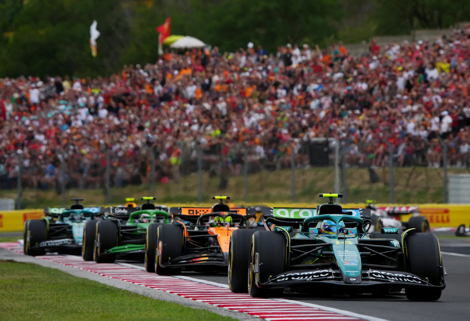 BUDAPEST, HUNGARY - AUGUST 03: Fernando Alonso of Spain driving the (14) Aston Martin F1 Team AMR25 Mercedes leads Lando Norris of Great Britain driving the (4) McLaren MCL39 Mercedes and Gabriel Bortoleto of Brazil driving the (5) Kick Sauber C45 Ferrari on track during the F1 Grand Prix of Hungary at Hungaroring on August 03, 2025 in Budapest, Hungary. (Photo by Malcolm Griffiths - Formula 1/Formula 1 via Getty Images)