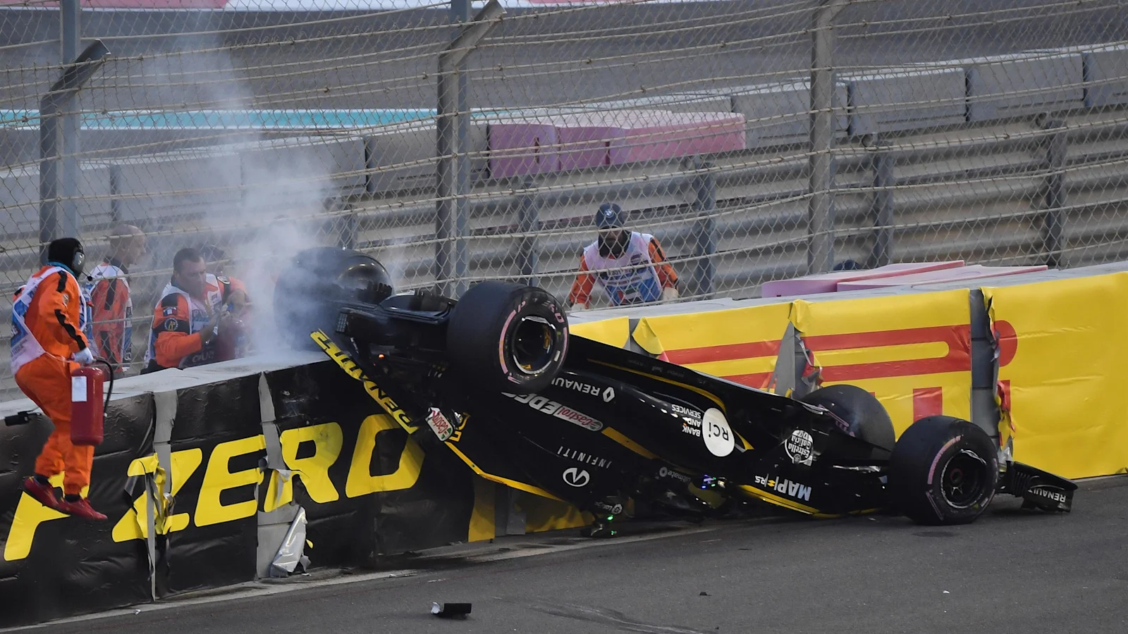 Marshals attend Nico Hülkenberg’s overturned Renault at Yas Marina Circuit during the 2018 Abu Dhabi Grand Prix.