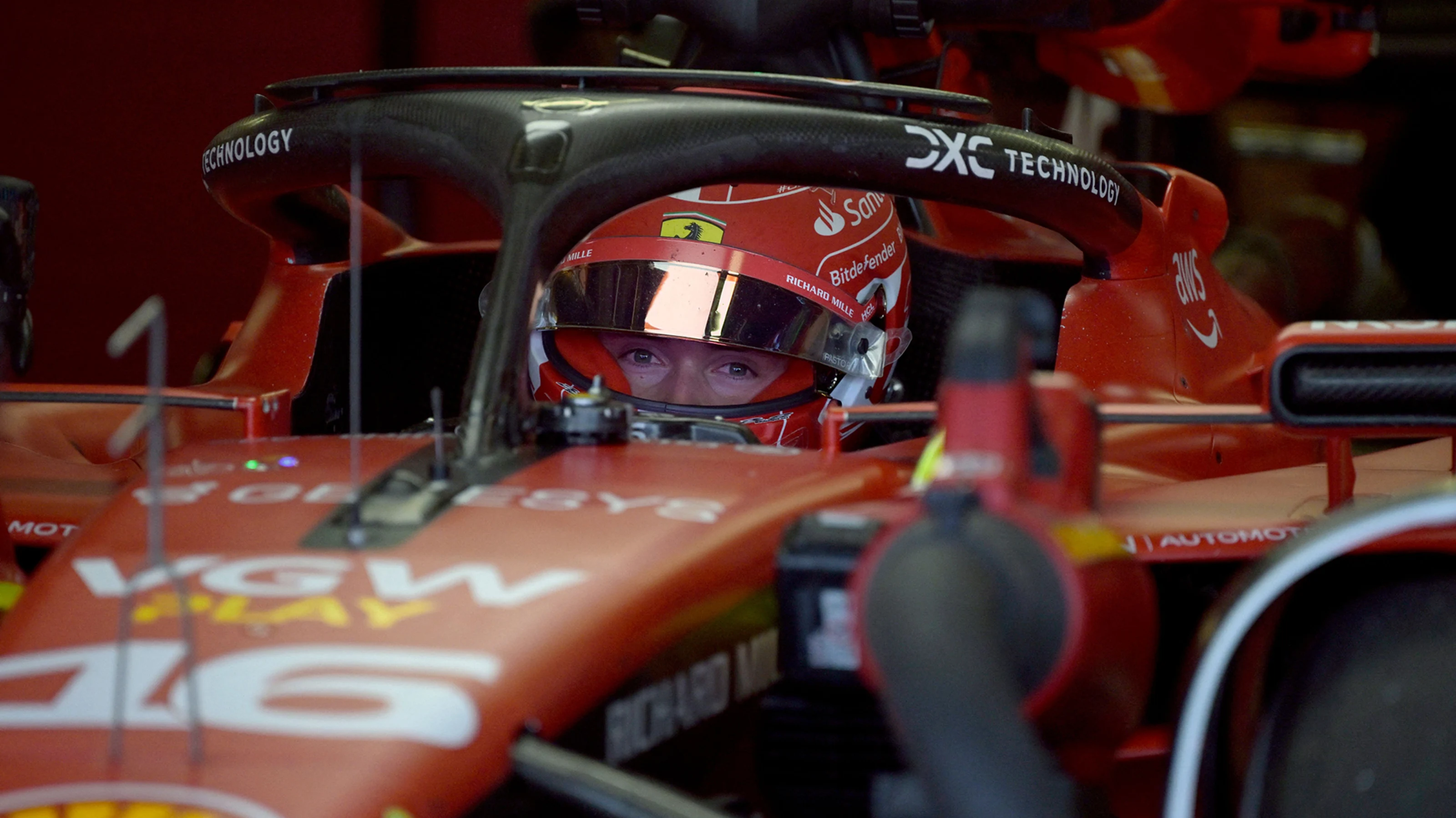 Ferrari's Monegasque driver Charles Leclerc is seen in his car inside the garage during the first