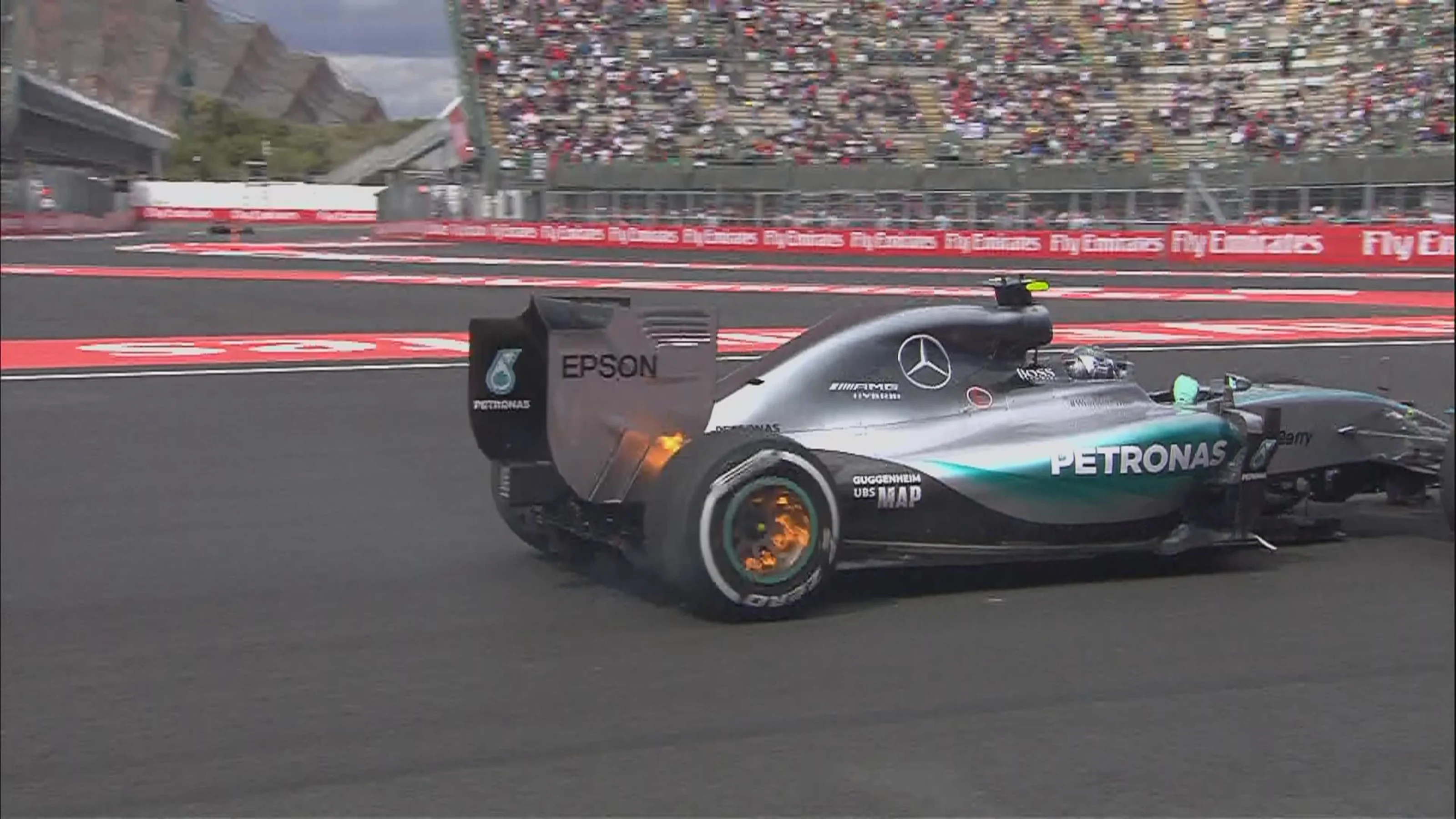 Rosberg`s rear brakes on fire as he quickly heads to the pits