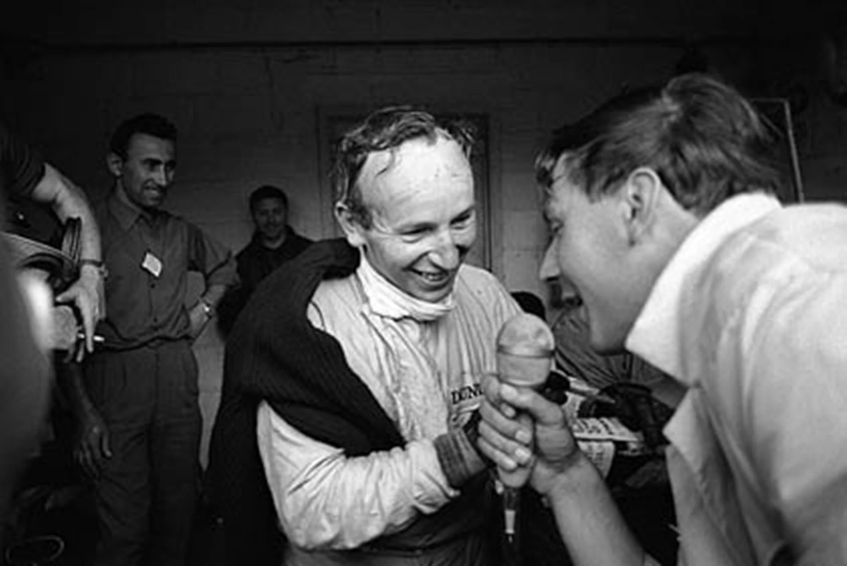 Spa, June 1966: A delighted John Surtees is interviewed following his dominant victory in the