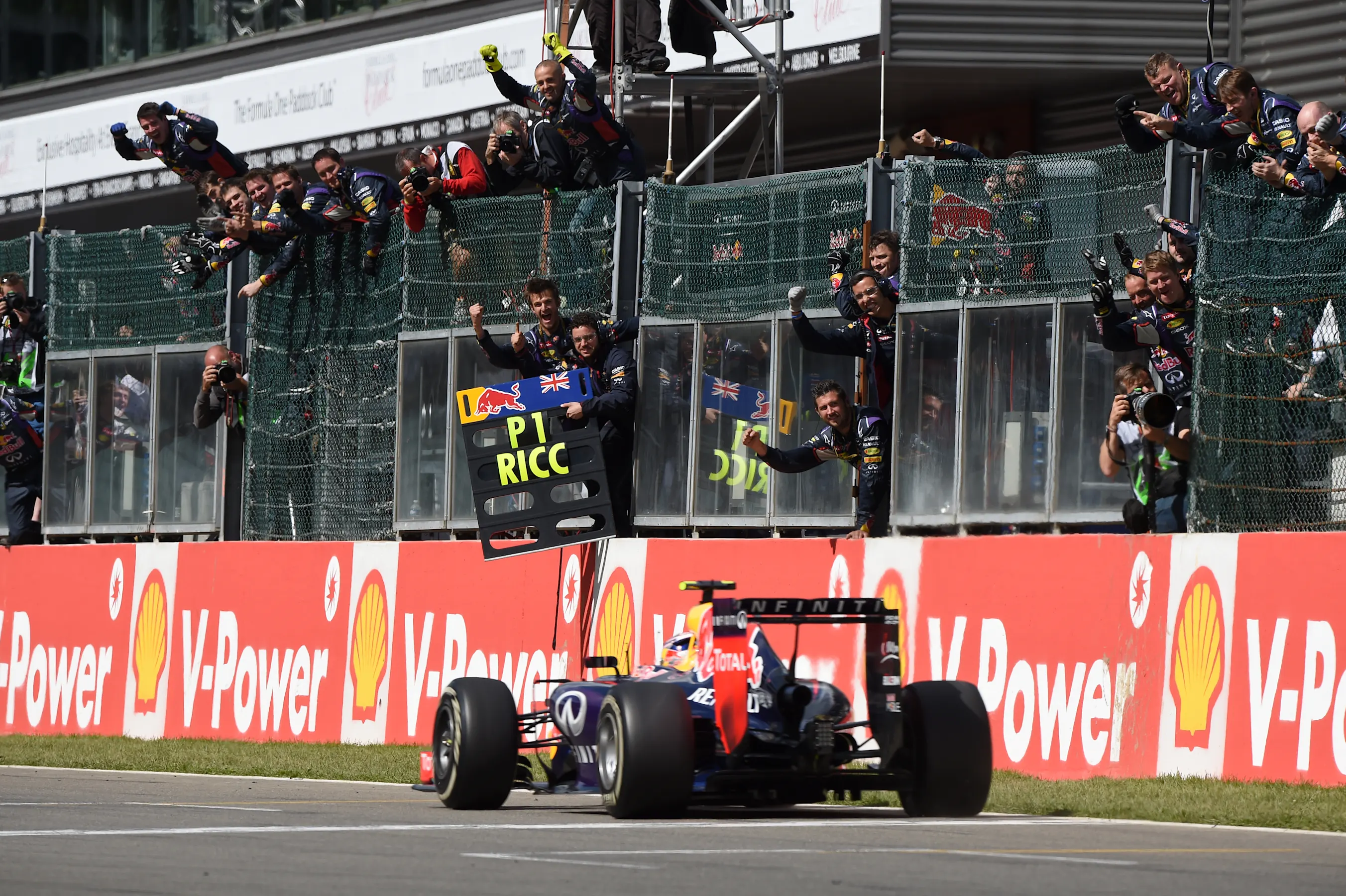 Race winner Daniel Ricciardo (AUS) Red Bull Racing RB10 crosses the line. Formula One World