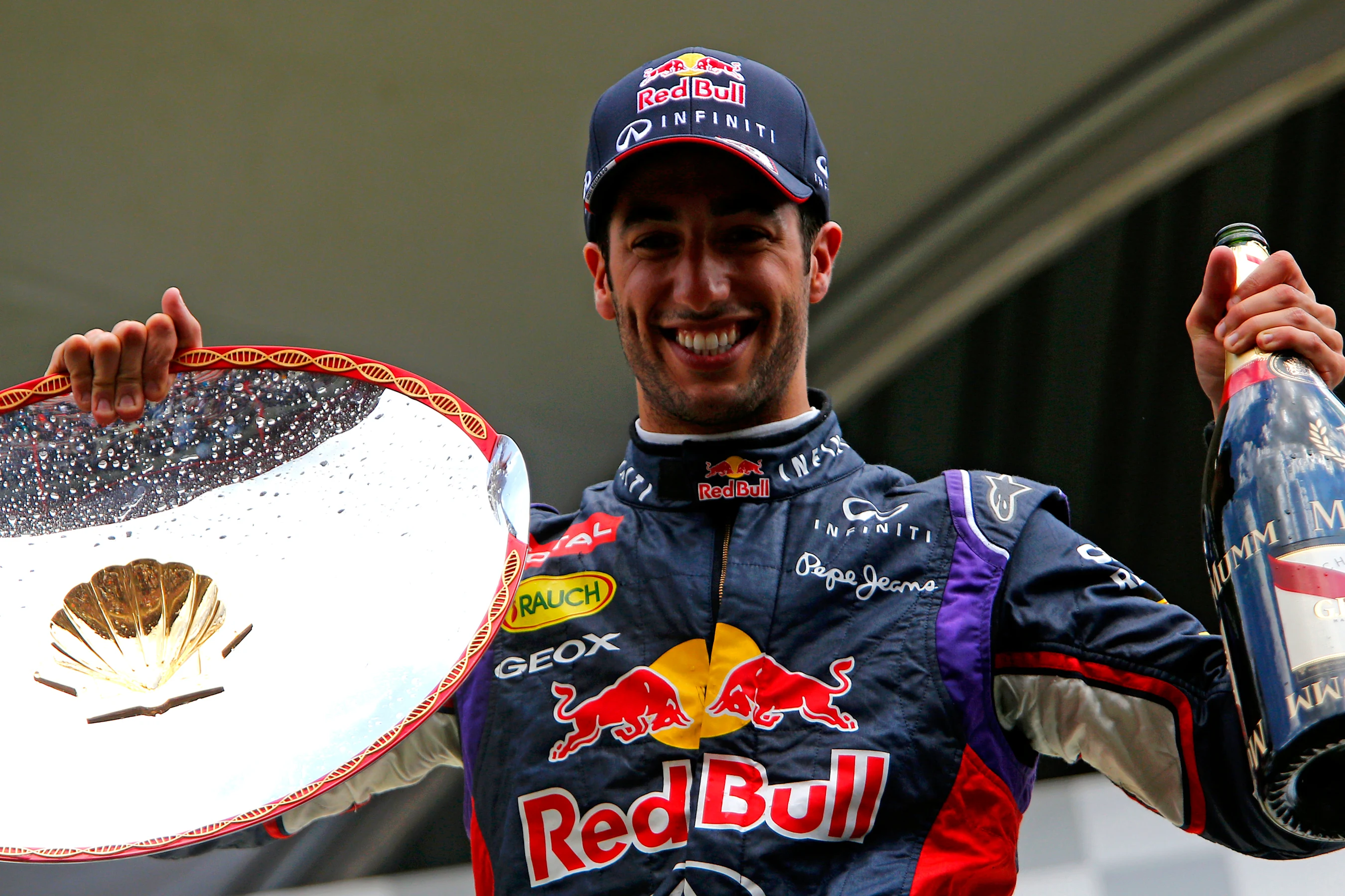 Race winner Daniel Ricciardo (AUS) Red Bull Racing with his trophy and champagne on the podium.
