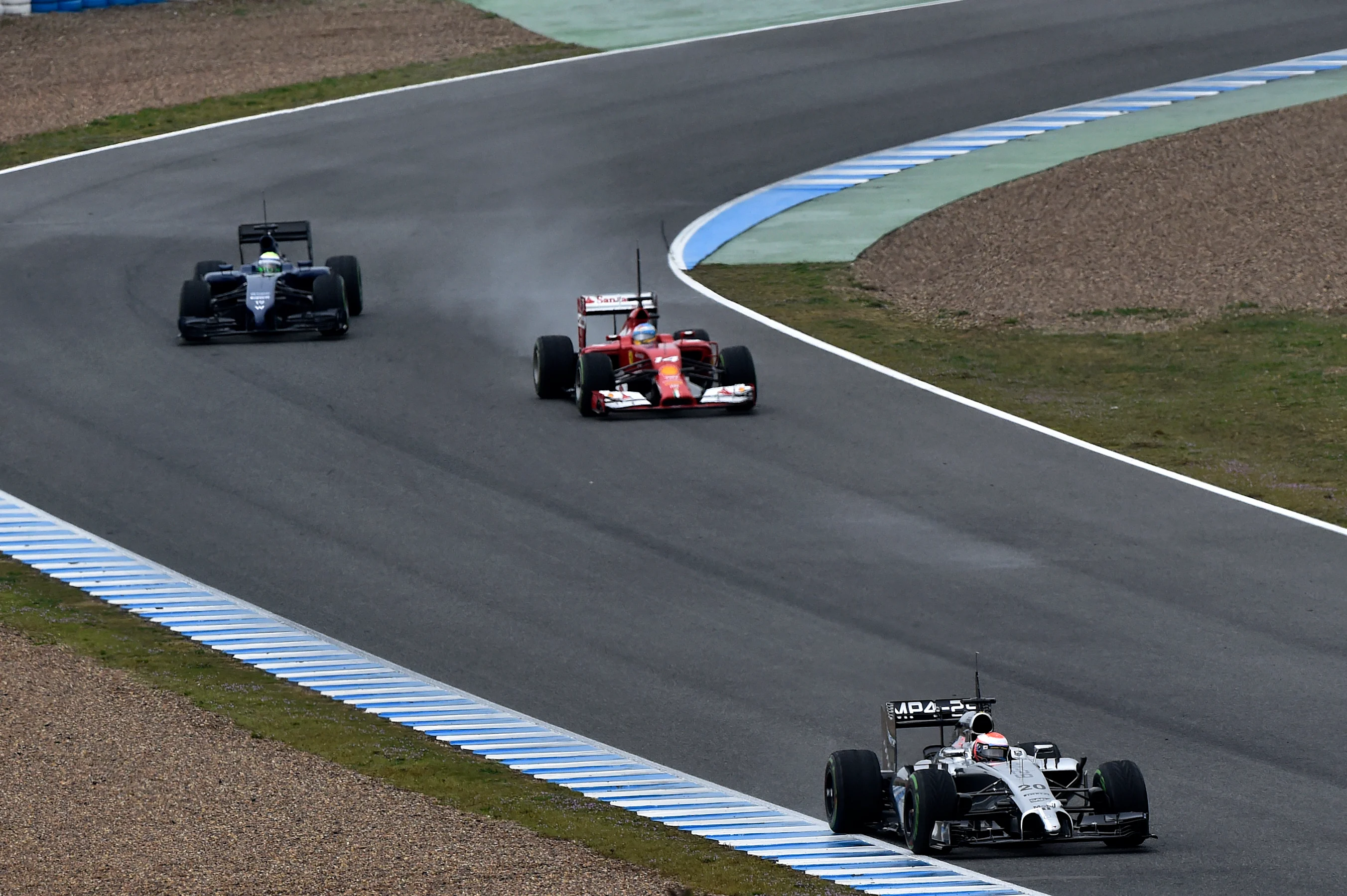 Kevin Magnussen (DEN) McLaren MP4-29 leads Fernando Alonso (ESP) Ferrari F14 T and Felipe Massa
