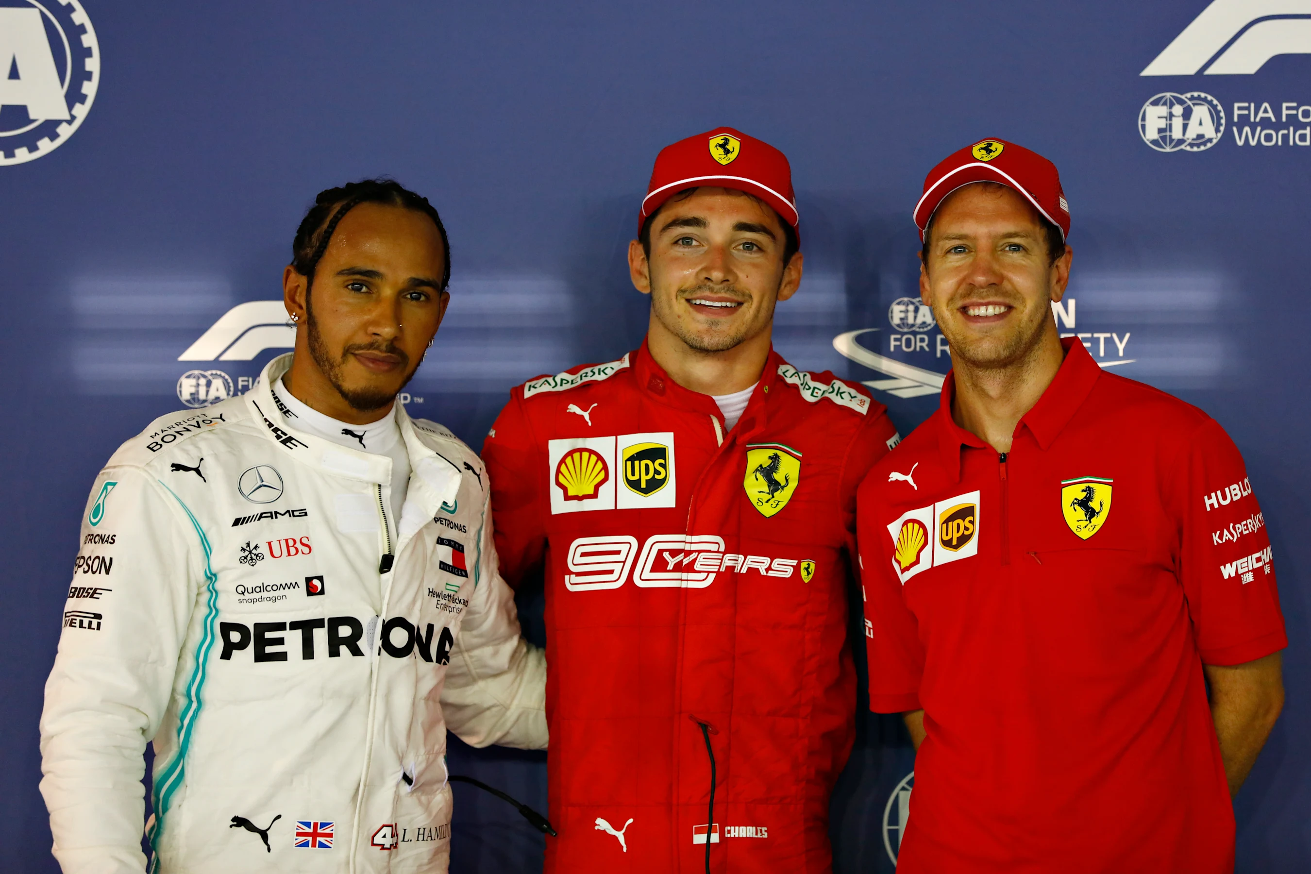 SINGAPORE, SINGAPORE - SEPTEMBER 21: Top three qualifiers Charles Leclerc of Monaco and Ferrari,