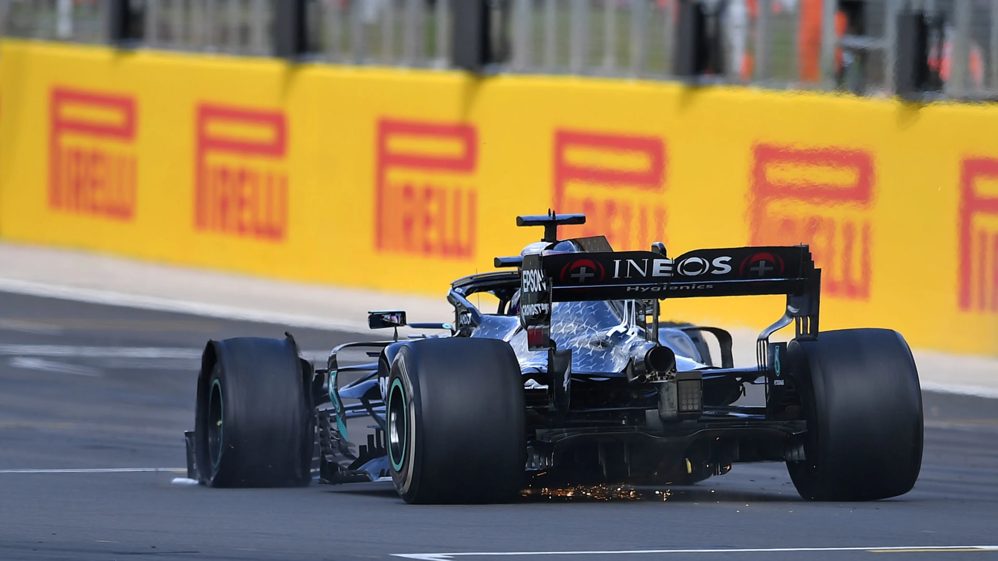 Mercedes' British driver Lewis Hamilton drives with a puncture before winning the Formula One