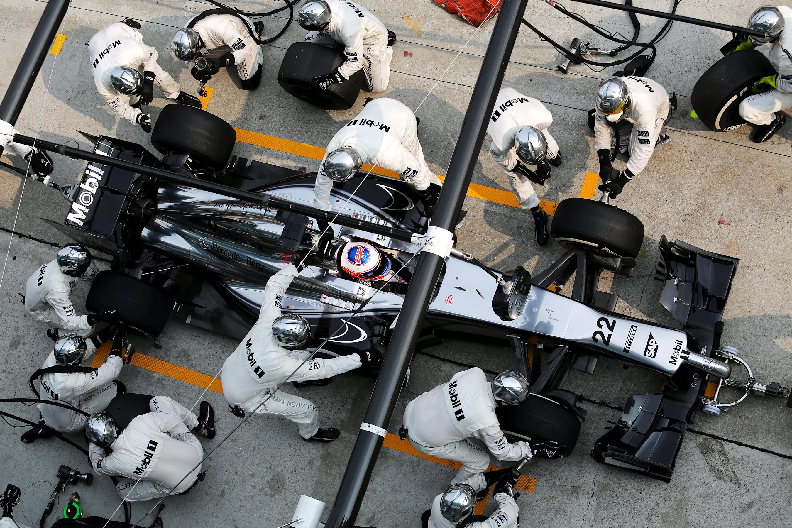 Jenson Button (GBR) McLaren MP4-29 makes a pit stop. Formula One World Championship, Rd2, Malaysian