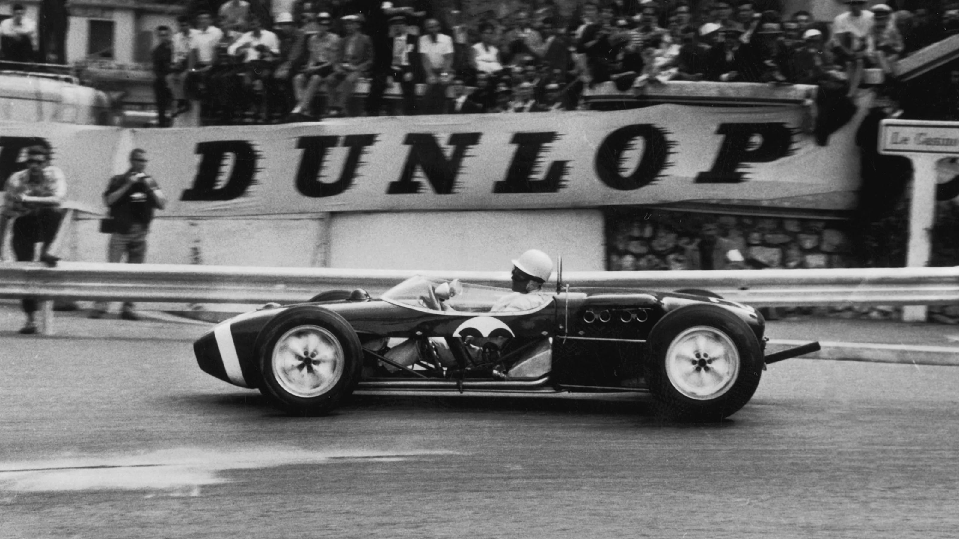 English racing driver Stirling Moss in a Lotus-Climax 18, with the side panels taken out, during